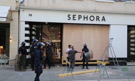 Riot officers guard a Sephora outlet in Marseille.