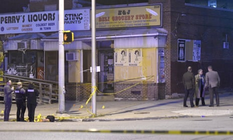 Police work near the scene of a shooting in Baltimore on 28 April 2019.