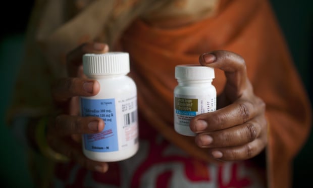 An Indian woman living with HIV holds antiretroviral drugs at her home in New Delhi on 23 July. Campaigners claim hundreds of thousands of people have had to cease medication.