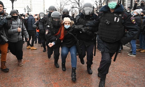 Police detain a woman in Moscow on Saturday. 