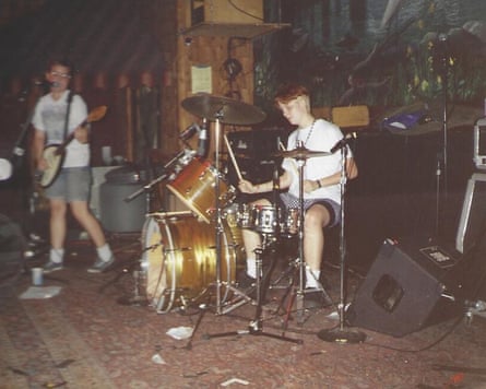 A vintage photograph of Heavens to Betsy playing on a messy carpeted stage