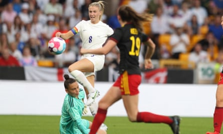 Leah Williamson in the air, competing for the ball with Belgian player