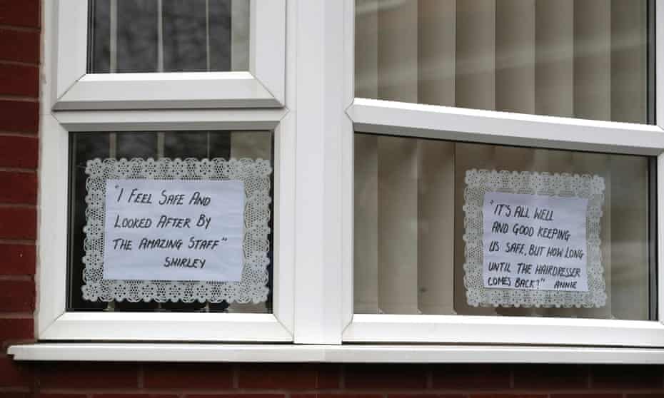 Messages from residents displayed on the windows of their care home.