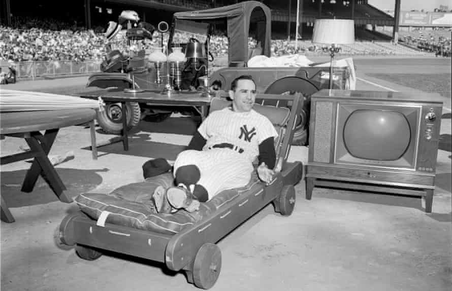 Yogi Berra lounges on one of the gifts he received during 'Yogi Berra Day' prior to a game at Yankee Stadium in 1959
