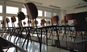 Picture of lots of chairs in tables in a classroom.