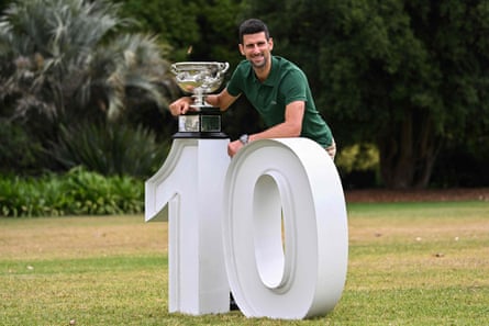 Djokovic poses with the Norman Brookes Challenge Cup trophy.