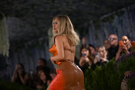 Kim Kardashian attends the Met Gala in orange breastplate and hand-painted leather skirt