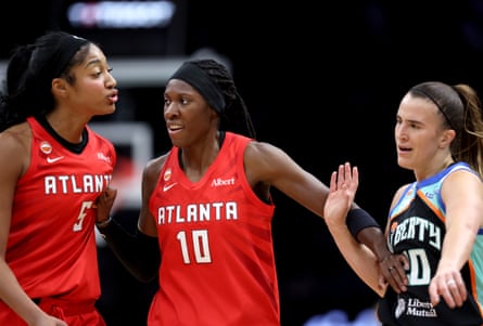 Atlanta’s Rhyne Howard separates teammate Angel Reese and New York’s Sabrina Ionescu during a heated exchange in Friday’s WNBA semi-final Game 3 in Brooklyn.