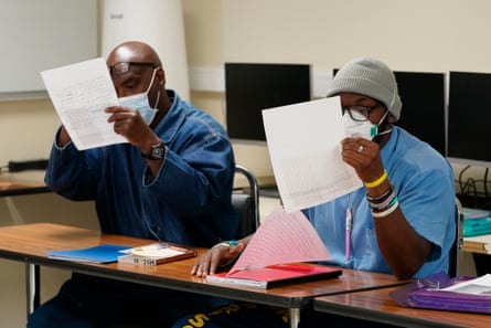 Students at San Quentin prison examining an image of The Falling Man