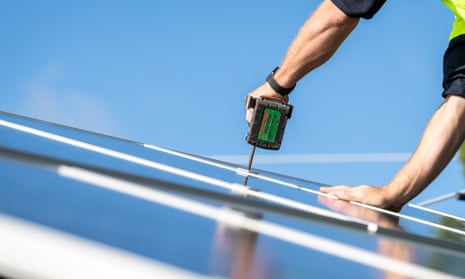 A person installing solar panels