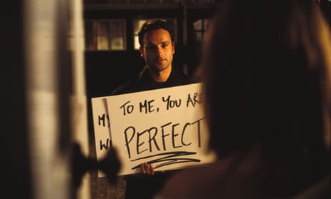 Still from Love Actually - man (played by Andrew Lincoln) shows 'To me you are perfect' poster to woman
