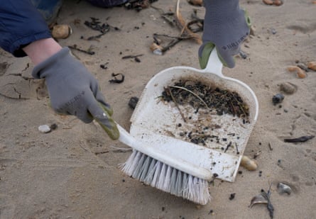 Some of the plastic beads swept into a dustpan