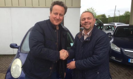 David Cameron shakes hands with Iain Harris, of Witney Used Car Centre.