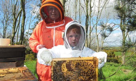 Norman Walsh with his grandson looking after the hives