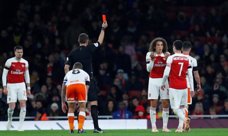 Arsenal’s Mattéo Guendouzi is shown a red card by referee David Coote after collecting two yellow cards. 