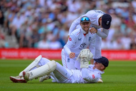 Joe Root of England celebrates with James Rew of England after the juggling catch of Tom Blundell of New Zealand.