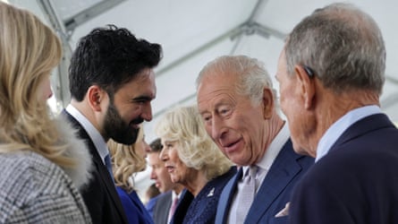 King Charles, pinch Queen Camilla beyond him, and Zohran Mamdani chatting