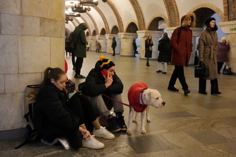 People rest in the subway station being used as a bomb shelter during an attack on Kyiv.