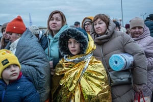 Refugees stand in queues stretching up to 10 miles before crossing the borders into Poland