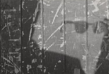 a shadow of a person holding glasses