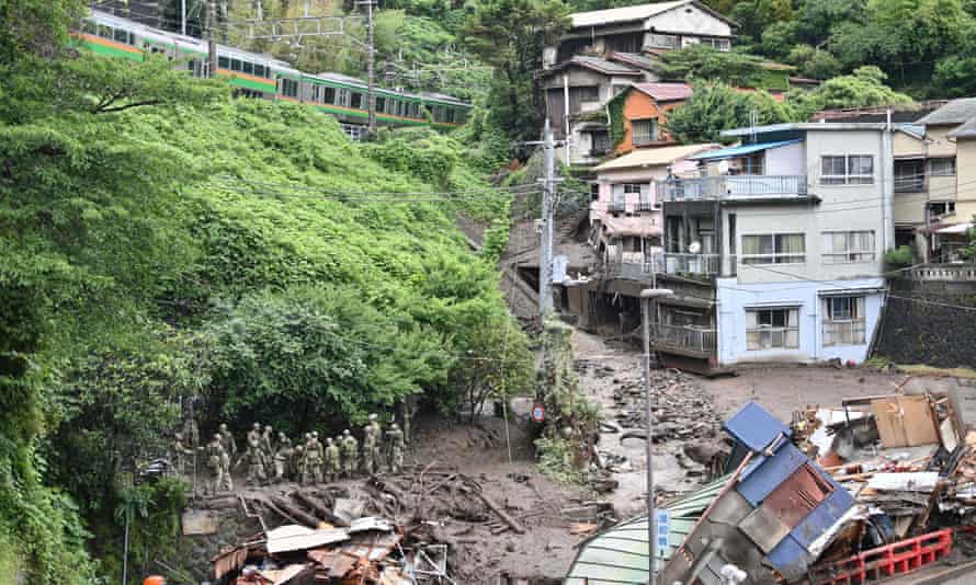 apan Self-Defense Force personnel search for missing people at the scene of a landslide following days of heavy rain in Atami in Shizuoka Prefecture on July 5, 2021.