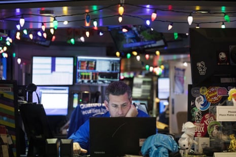 A stock trader works at the New York Stock Exchange today