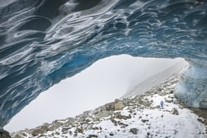 Mountain guide Daniel Ruppen visits an ice cave formed at the end section of the Zinal glacier.