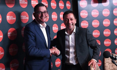 Daniel Andrews shakes hands with Matthew Guy  while both men smile for the camera