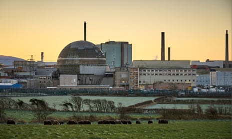 The spherical concrete reactor ands other buildings at Sellafield against a pale sunset, with animals in the fields in the foreground