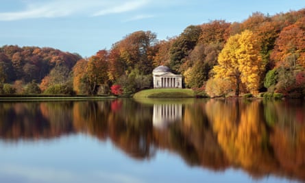 Pavilion and autumn trees reflected in water