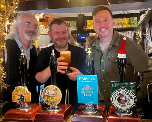 David Thorold, Martin Belam and Sean Hughes behind the bar of The Boot pub in St Albans
