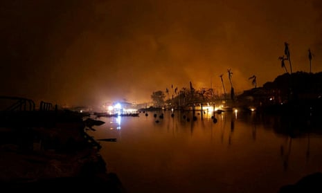 Flames burn near Lahaina as wildfires driven by high winds destroy a large part of the historic Hawaii town.