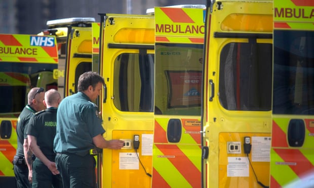 NHS workers prepare a line of ambulances outside at the NHS Nightingale Hospital at the Excel Centre in London