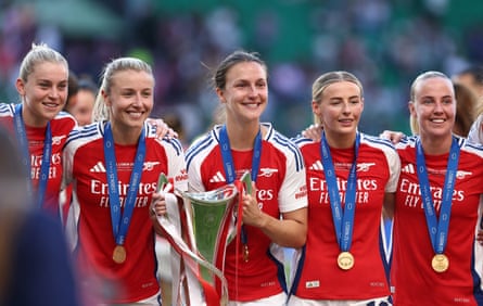 Arsenal women’s players hold the Champions League trophy after winning it