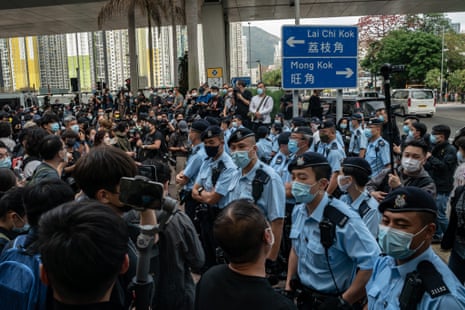 Pro-democracy protesters come up against a group of police officers in front of West Kowloon court in Hong Kong
