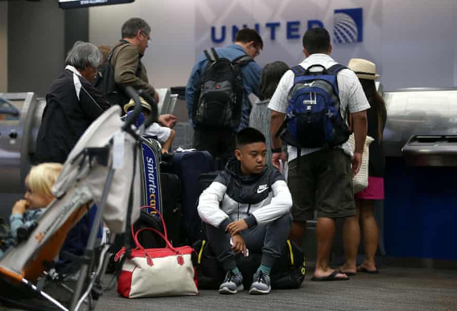 Passengers at a United Airlines ticket desk