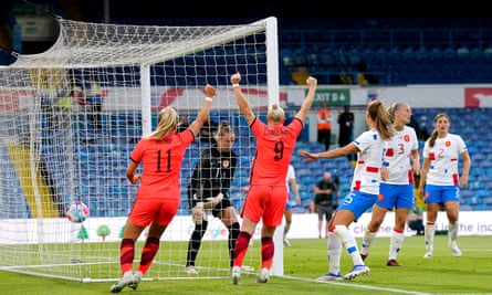 Lauren Hemp and Beth England celebrate after Lucy Bronze’s effort lands in the net to equalise