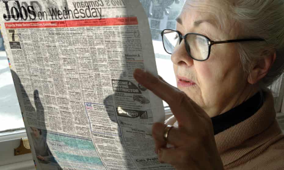 A woman reading her local newspaper.