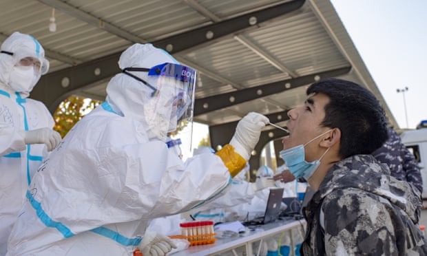 A medical worker collects a saliva sample in Shufu county in southern Xinjiang.