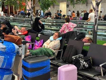 People sleep in the airport departure lounge, on chairs and on the floor