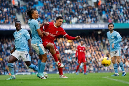 Trent Alexander-Arnold holds off Nathan Aké during the match.