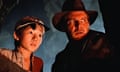 film still of man in a hat and child looking at something