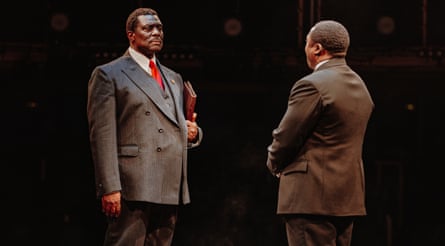 Two actors wearing suits on stage