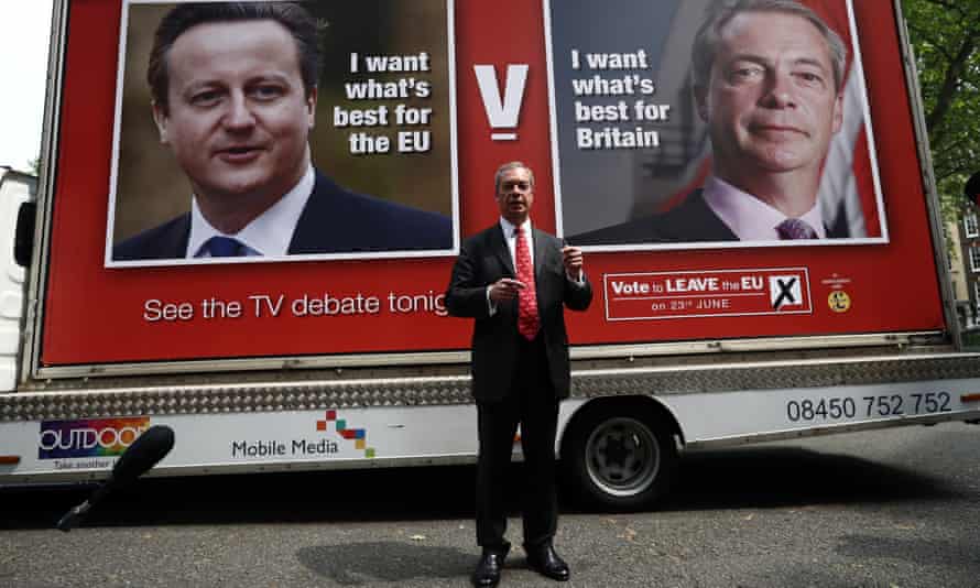 Nigel Farage poses for photographers as he unveils a new campaign poster ahead of a televised debate with David Cameron.