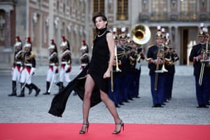 Charlotte Gainsbourg on a red carpet, with a military band behind