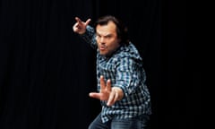 Jack Black stiking a pose with hands outstretched.