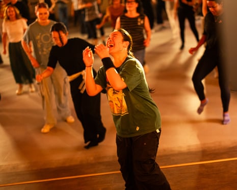 A woman taking part in a dance class appears overcome with joy