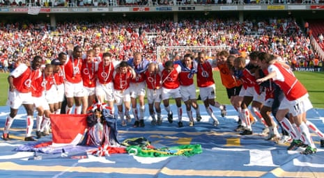 The 2004 Invincibles celebrate with the Premier League trophy.