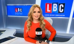 Carol Vorderman sitting at a desk with a microphone on in an LBC studio.