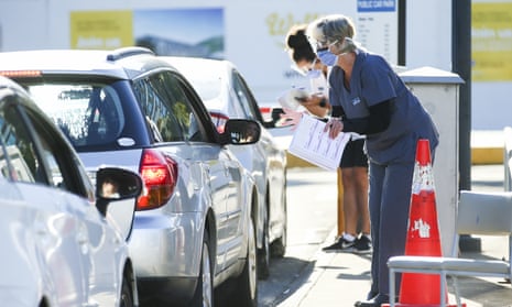 Staff talk to drivers arriving at a New Zealand hospital.